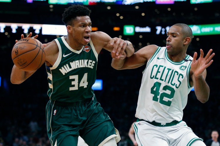  Al Horford of the Celtics defends Giannis Antetokounmpo of the Bucks during Milwaukee's 113-101 win in Game 4 of their Eastern Conference semifinal series on Monday in Boston.