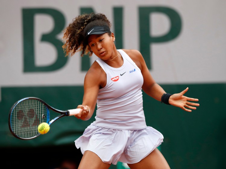 Naomi Osaka, the top seed at the French Open, plays a shot against Anna Karolina Schmiedlova during their first round match Tuesday at Roland Garros in Paris, Tuesday. Osaka rallied to win 0-6, 7-6 (4), 6-1.