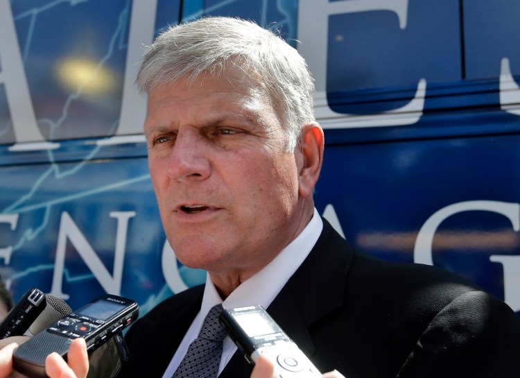 Evangelist Franklin Graham speaks to media in front of his bus after a mass prayer rally on Boston Common in 2016 in Boston. Graham, the son of famed evangelist Billy Graham, is holding a 50-state "Decision America" tour to urge evangelicals to vote.
