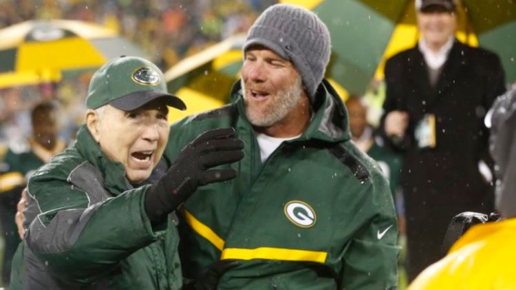 Brett Favre smiles with Bart Starr during a ceremony at halftime of a 2015 game at Lambeau Field. Favres retired No. 4 and name were unveiled. Starr died Sunday at the age of 85.