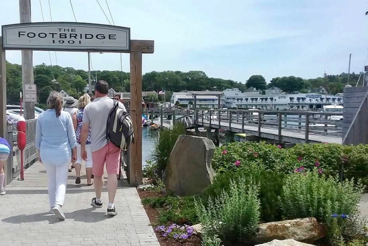 The footbridge at Boothbay Harbor is a good place to wait and watch for the windjammer fleet to arrive during Windjammer Days.