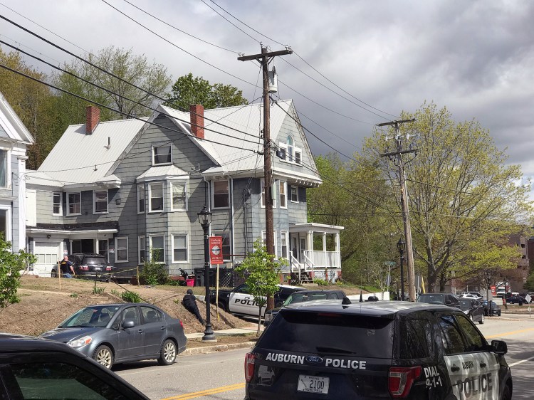 Law enforcement officers surround a house May 21, 2019, at 185 Main St. in Auburn.