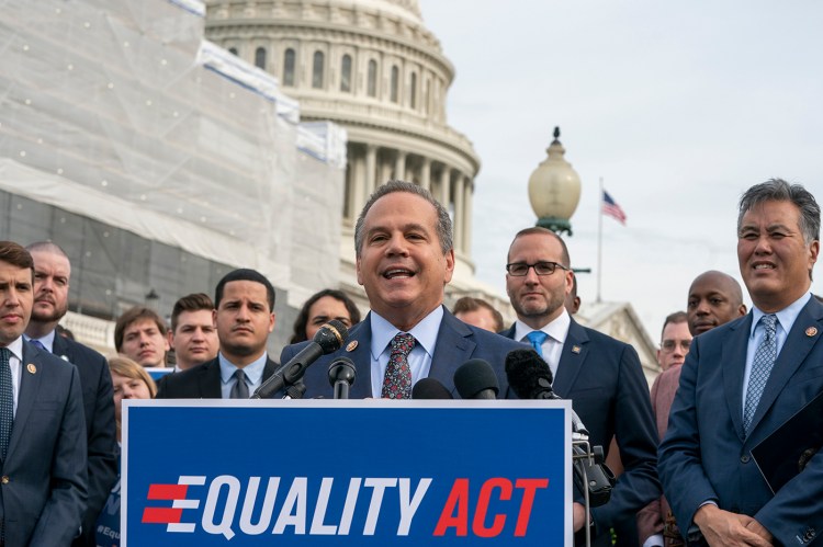 Rep. David Cicilline, D-R.I., joined at right by Chad Griffin, president of the Human Rights Campaign, and Rep. Mark Takano, D-Calif., at a rally before a House vote on the "Equality Act of 2019" on Friday.