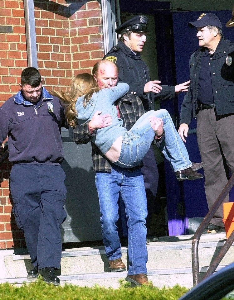 Actor Ed Harris carries a girl out of Waterville High School, where a shooting scene in the "Empire Falls" movie was filmed in 2003. Behind Harris is actor William Fichtner, who played a police officer in the 2005 TV movie miniseries filmed throughout central Maine. Harris has pledged $75,000 for the future Paul J. Schupf Art Center being planned for 93 Main St. in downtown Waterville. 