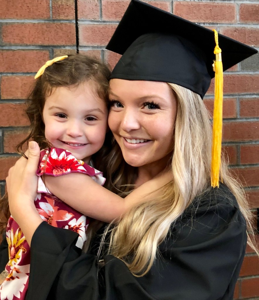 Kennebec Valley Community College graduate Jasmyne Overlock of Waterville poses with her daughter, Riyen Denis, 4, following Saturday's commencement ceremony in Augusta.