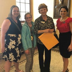 Jess McGreevy and Charlotte McGreevy stand with Oxford County Teacher of the Year Linda Andrews, who received a legislative sentiment from Sen. Lisa Keim at the State House on May 9.