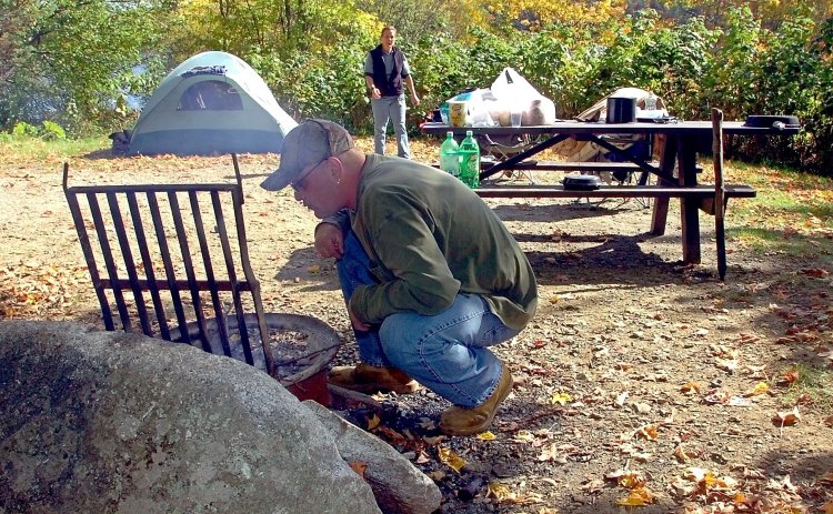 Lance and Donna Woodward prepare to cook lunch on a fire at their campsite at Lake St. George State Park in Liberty, where they had been camping for a week in 2015. 