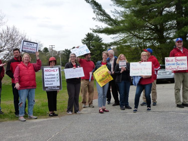 Merrymeeting Teacher Associations members and supporters stand near the entrance to Mt. Ararat Middle School on Thursday before the start of the School Administrative District 75 budget meeting.