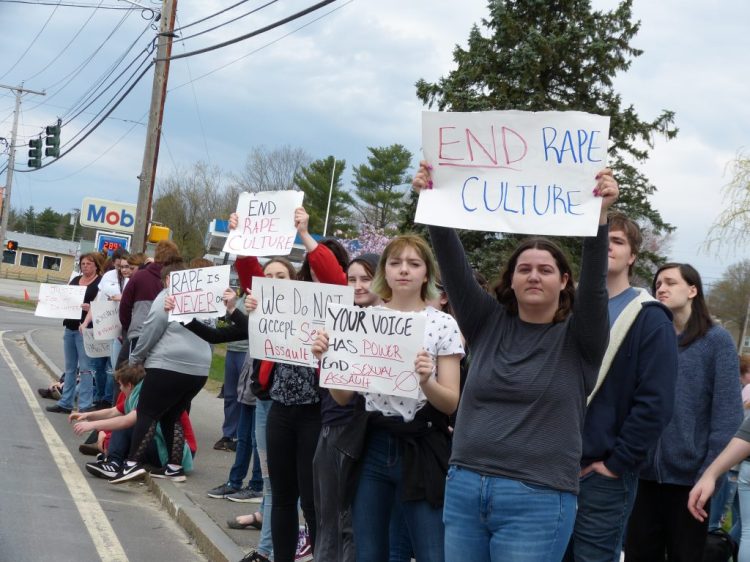 Lisbon High School students stand along Route 196 outside the school May 7 as they protest the way the school had handled a rape that reportedly occurred in the school parking lot a few weeks ago. The Times Record photo by Darcie Moore