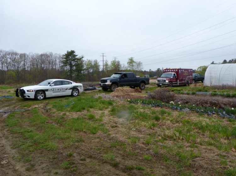 Emergency vehicles parked at East of Eden Flower Farm in Bowdoinham, near where police recovered a body from Merrymeeting Bay Friday morning. 