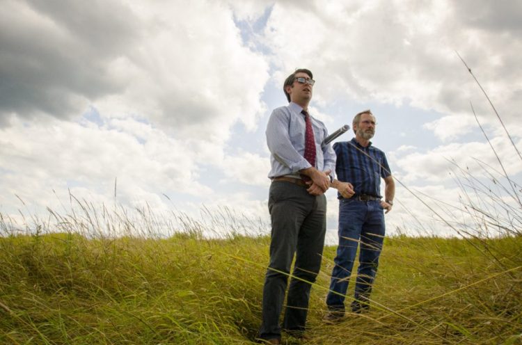 Garvan Donegan, Central Maine Growth Council senior economic development specialist, left, and Greg Brown, former Waterville city engineer, survey the landfill off Webb Road in Waterville in August 2017, where plans to site a solar farm came to fruition. The City Council will take the first vote Tuesday on approving leases with the developer for the city's landfill and the former Runser property.