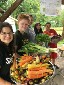 Students at the Alan Day Community Garden prepare vegetables for their meals and to distribute to the community as part of the Youth Leadership Program.