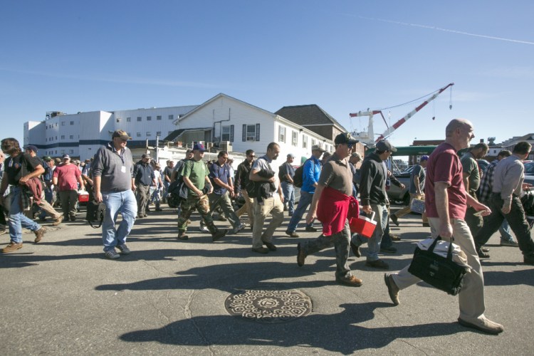 Workers leave the main gate at Bath Iron Works. Union officials are seeking clarification on new pension rules that have some workers worried about retirement ages and benefits.
