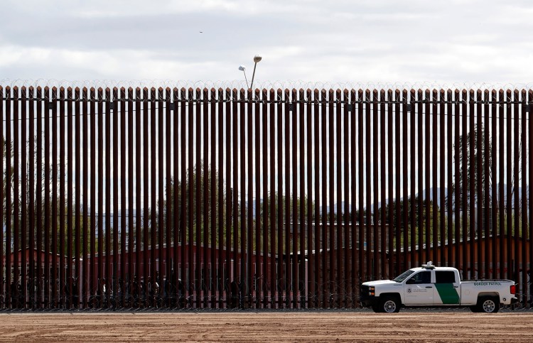Customs and Border Protection vehicles are seen on the U.S. side of a section of border fence in Calexico, Calif.

