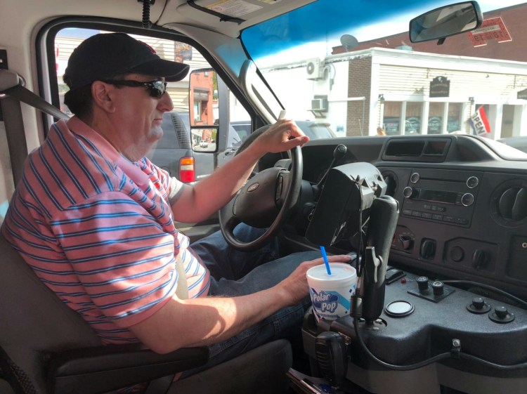 Walt Webber drives the Western Maine Transportation Services bus Thursday afternoon from Wilton to Farmington. Webber has been driving the bus, which offers low-fare service to Franklin County residents, for about five years. 