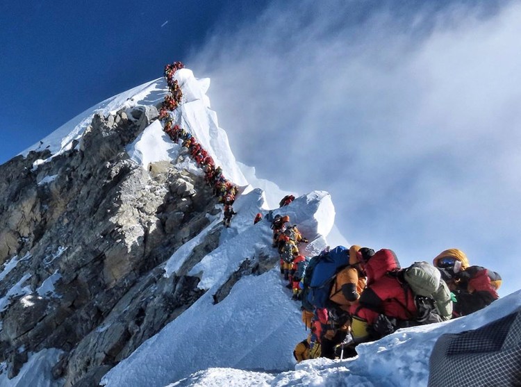 A long queue of mountain climbers line the path to the summit of Mount Everest in May.