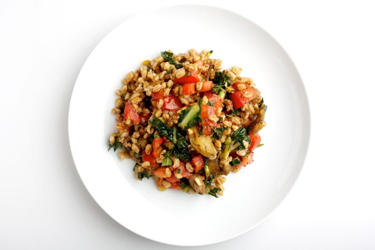 Eating ancient grains such as farro, shown in a salad with tomatoes, grilled vegetables and kale, can help support biodiversity. MUST CREDIT: Photo by Deb Lindsey for The Washington Post.