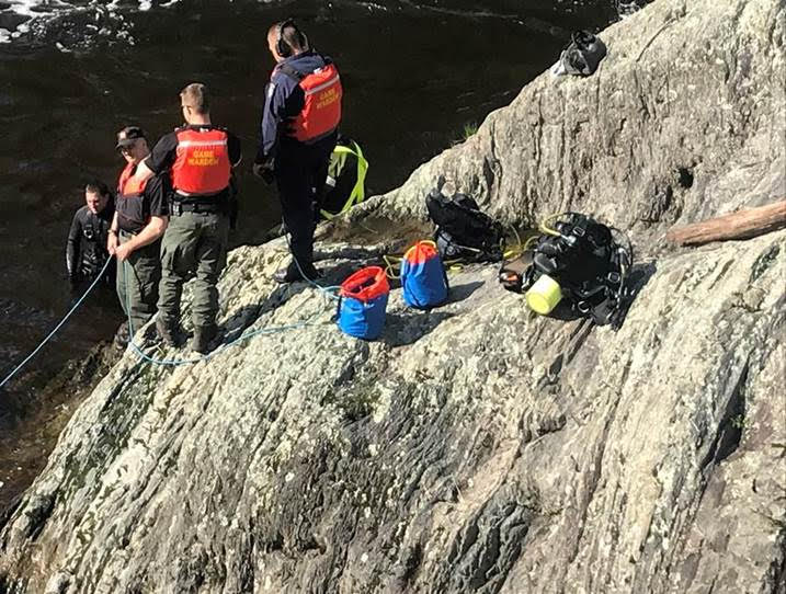 Maine Warden Service Dive Team members assist a diver who recovered the body of a 41-year-old man who fell into the Kenduskeag Stream in Bangor.

