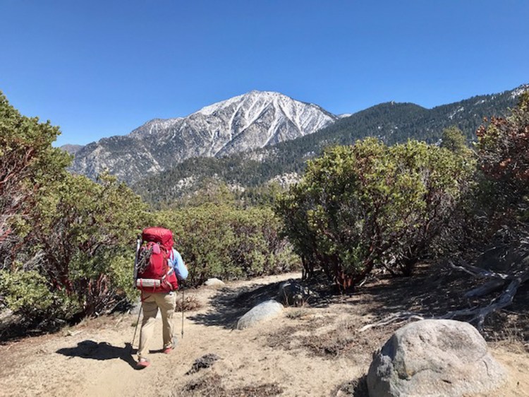 A Pacific Trail hiker descends the trail on snowy 10,800-foot Mt. San Jacinto. 