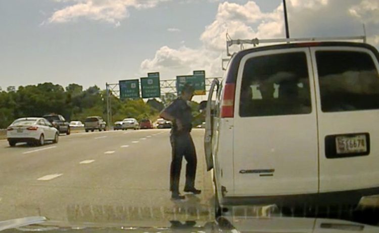 In this photo taken from the video dashboard camera of Maine State Police Trooper Robert Burke III, the trooper talks to the driver of a van carrying about a dozen immigrants on Interstate 295 in Portland on Sept. 9, 2017. Burke eventually contacted U.S. Immigration and Customs Enforcement.