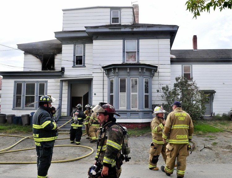 Firefighters from several area departments extinguish a fire on Oct. 2, 2012 that caused serious damage to this apartment building at 19 Western Ave. in Waterville. The city of Waterville has reached a settlement with the owner of the building. Leonard D. Poulin has until July 15 to repair it.