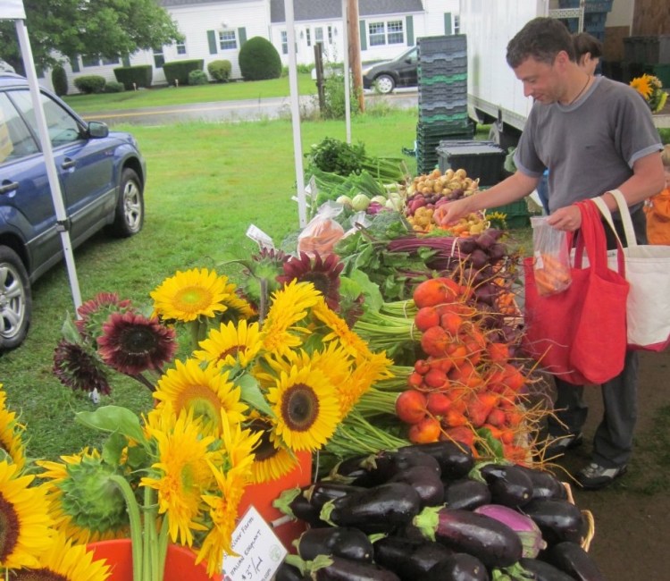Customers shop at the Crystal Spring Farmers’ Market. The market is one of 30 in the state that now exchanges SNAP benefits for “Harvest Bucks,” which work to provide more low-income families access to fresh, local produce.