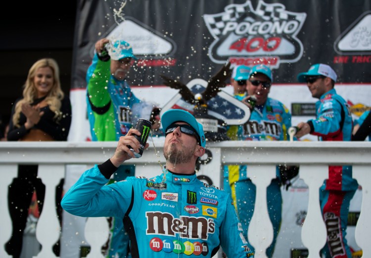 Kyle Busch celebrates in victory lane after winning a NASCAR Cup Series auto race at Pocono Raceway, Sunday, June 2, 2019, in Long Pond, Pa. (AP Photo/Matt Slocum)