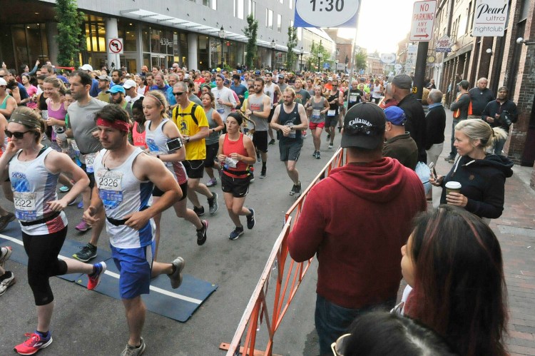 Runners head for the start line at the beginning of the 2018 Old Port Half Marathon in Portland. Last year's race was called off because of the pandemic, but registrations have already started for this year's race, scheduled for June 5.