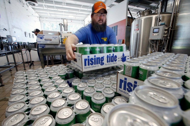 Merritt Waldron, director of quality control at Rising Tide Brewing Company stacks a case of MITA on a growing pallet. C&R Research named Portland the No. 1 city in America for number of craft breweries per 50,000 people. .