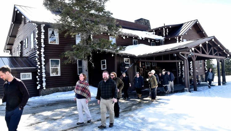 Unity College administrators and staff members exit Sky Lodge in Moose River to tour the property in March 2018. John and Elaine Couri, of the Couri Foundation, have added a welcoming center to their gift to the college.