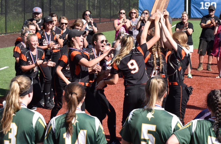 Members of the Skowhegan softball team celebrate after they defeated  Oxford Hills in the Class A North title game Wednesday at Colby College.