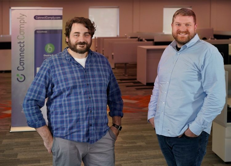 Stephen Quirk, left, and Sam Hotchkiss pose for a photo in the office of their startup company, Call2Test, in Cumberland. The company has developed an app to improve efficiency and accountability of people on probation or parole. 