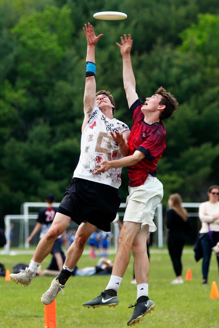 NEW GLOUCESTER, ME - JUNE 1: Cape Elizabeth's Calvin Stoughton, left, makes a scoring catch despite pressure from Cumberland's Aidan Hayes during the high school Ultimate state championship game at New Gloucester Fairgrounds on Saturday. Cape Elizabeth bested Cumberland 15-3 to earn the title. (Staff photo by Ben McCanna/Staff Photographer)