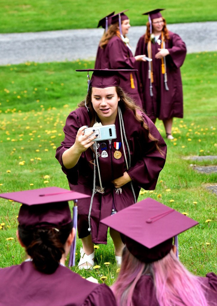 Maine Central Institute senior Macy Basford photographs fellow seniors before the school's 150th commencement Sunday in Pittsfield.