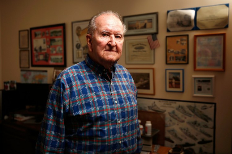 Bob Ryan, photographed in front of a wall covered with his war memorabilia, was a member of the U.S. Navy's Seabees during World War II and arrived on Omaha Beach just hours after U.S. forces pushed the Germans inland on D-Day.