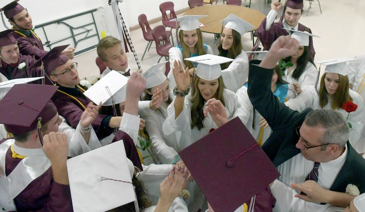 Monmouth Academy Principal Rick Amero leads seniors in a group cheer before marching into graduation ceremonies June 9, 2019. For this year's ceremony the students, and Amero, won't be able to be that close, but they will all graduate together in a socially distanced ceremony.
