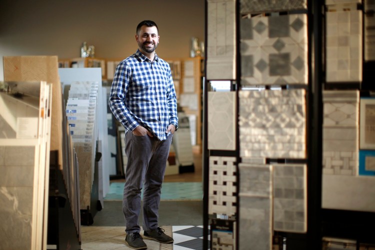 Joe Capozza III, president of Capozza Tile & Flooring, poses in the showroom of his family business. His family has tapped the services of the Institute for Family-Owned Business to ensure a professionally run company.