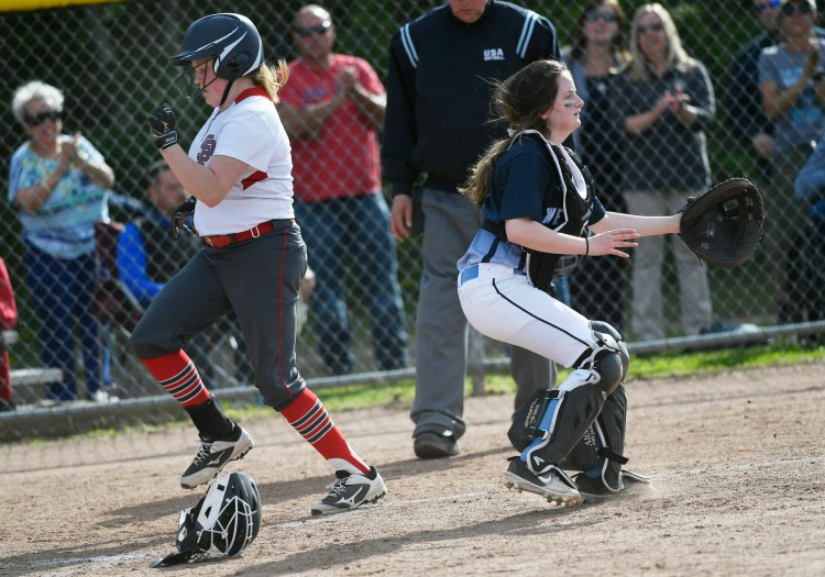 South Portland's Cortney Luce scores as Westbrook catcher Whitney Poitras waits for the throw in Tuesday's Class A South softball prelim. South Portland won 8-2.