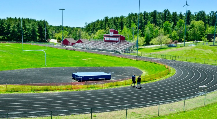This photo, taken Friday, shows two walkers on the Taylor Harmon Track at Cony High's Alumni Field complex in Augusta.