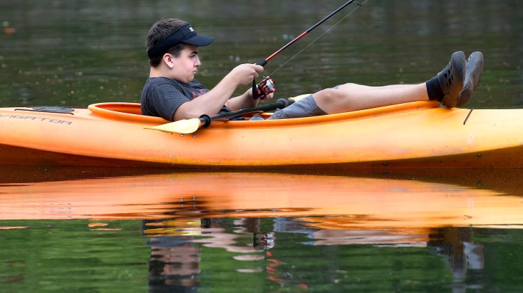 Eric Croteau, 15, casts for fish while kayaking on Wilson Pond in Monmouth last year. New federal data show nearly 5 percent of Maine's economy can be attributed to outdoor recreation.