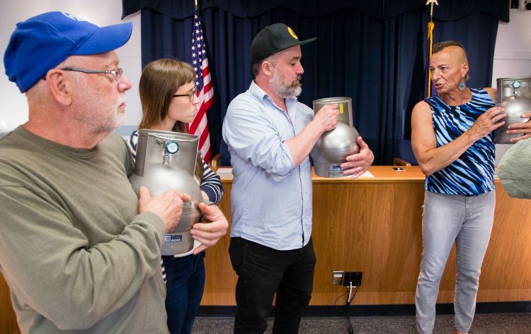 Maine DEP Air Bureau Senior Chemist Danielle Twomey, right, trains South Portland residents to use portable air collection canisters Monday at South Portland City Hall. Air quality around the city will be monitored by residents and analyzed by Twomey and her staff. The residents are, from left, Jay DeMartine, Annika Frazier and Ryan Frazier.