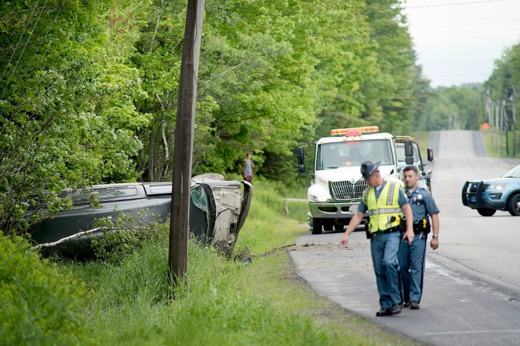 Maine State Police officers investigate the one vehicle crash on Route 4 in Turner on Tuesday afternoon.