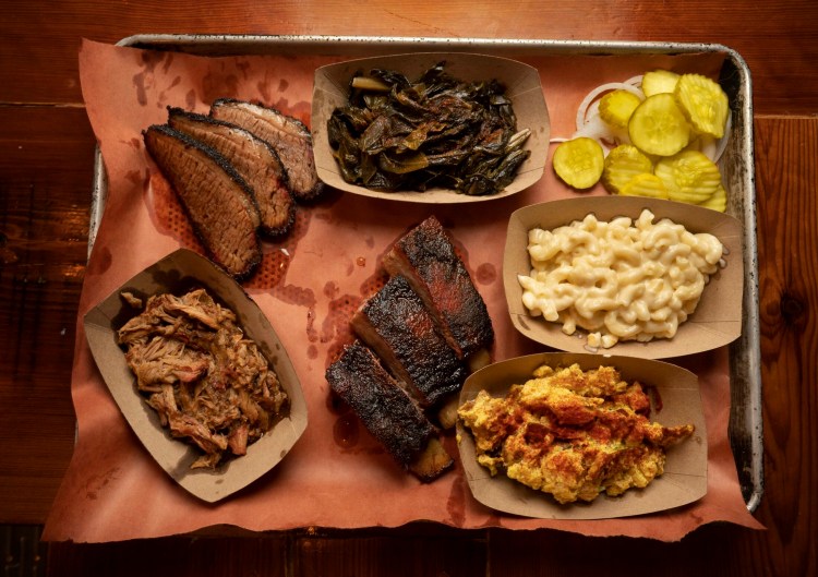 Ore Nell's shared Barbecue Platter. Clockwise from bottom left: pulled pork, brisket, collard greens, pickles and onions, mac and cheese, potato salad and St. Louis style ribs.