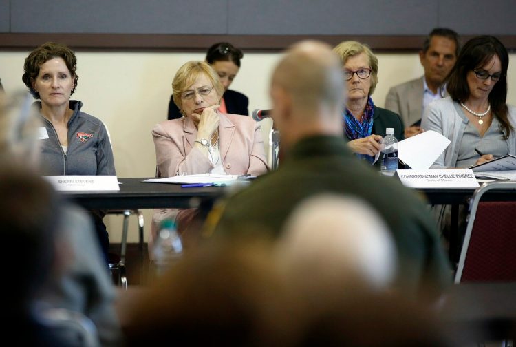Gov. Janet Mills, center, U.S. Rep. Chellie Pingree, to her left, and others listen to Jason Owens of the U.S. Border Patrol during Friday's meeting to discuss the asylum-seeker surge into Portland.