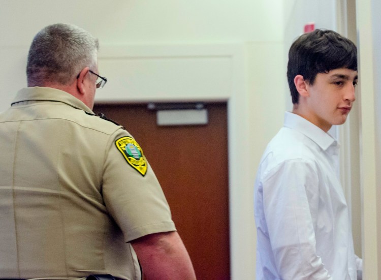 A Kennebec Country sheriff's deputy escorts William Smith, one of three teens charged in the April 2018 death of Kimberly Mironovas, out of the courtroom June 19 at the Capital Judicial Center in Augusta during a break. 