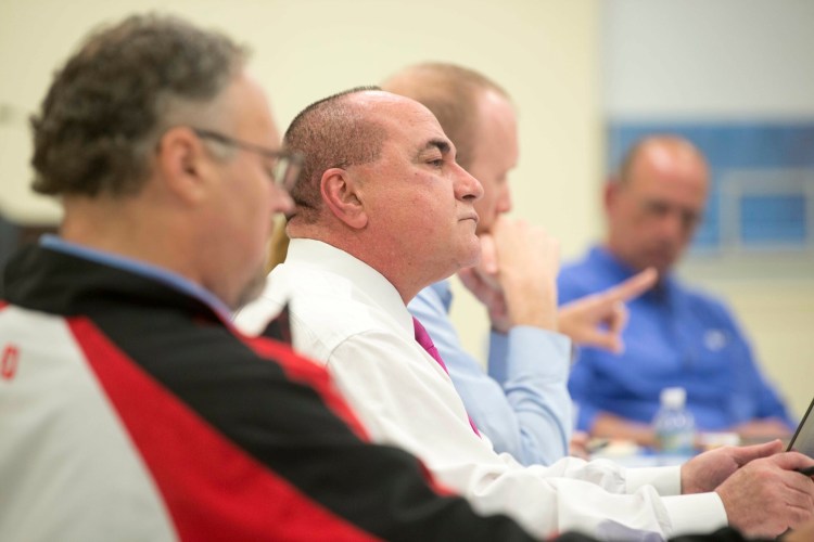 Superintendent Reza Namin, center, listens Thursday during a School Administrative District 49 board meeting at Lawrence Junior High School in Fairfield.