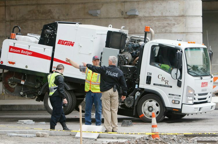 Police reconstruct the events that led to a construction worker being killed by a  street sweeping vehicle on Main Street in Yarmouth on Friday. 