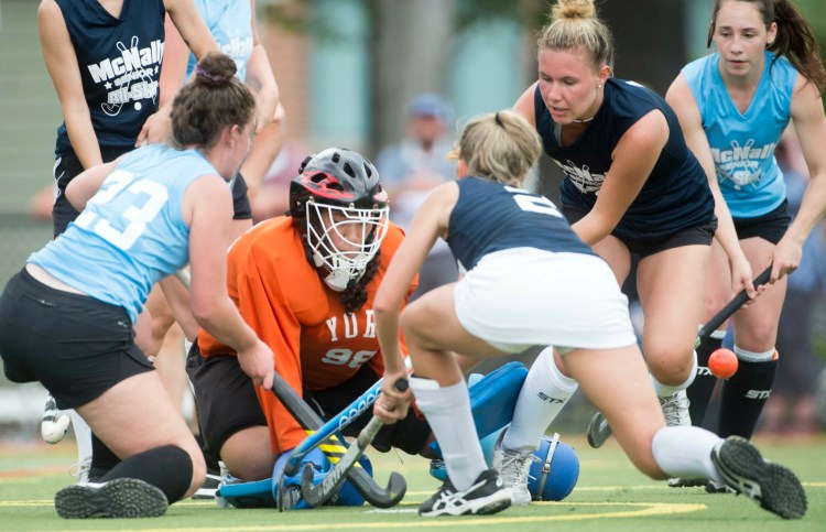 South goalie Julianna Kiklis (98) of York protects the goal as South's Paige Laverriere (2) of Biddeford defends while North's Kaitlyn Smith (23) of Messalonskee tries to score in the McNally All-Star game Saturday at Thomas College in Waterville.