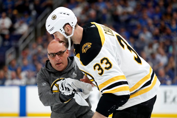 Boston Bruins defenseman Zdeno Chara leaves the ice after being hit in the face with a puck during the Bruins' 4-2 loss to the St. Louis Blues in Game 4 of the Stanley Cup finals on Monday in St. Louis. The Blues evened the series at 2-2.