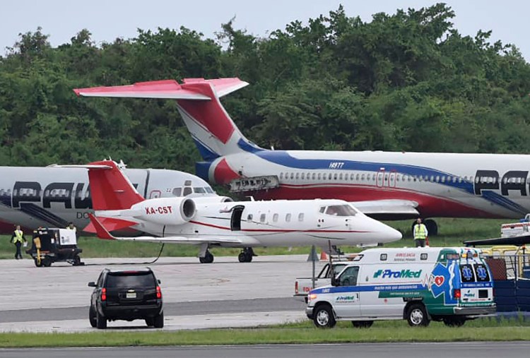 The ambulance carrying David Ortiz arrives to transfer him to the small ambulance plane parked at Las Americas Airport in Santo Domingo, Dominican Republic, for Monday's flight to Boston. Doctors removed Ortiz's gallbladder and part of his intestine after he was ambushed by a gunman at a bar in his native Dominican Republic.